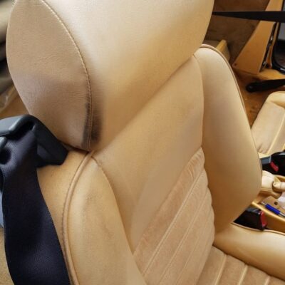 The interior of a car with tan leather seats.