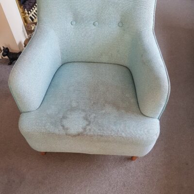 A light blue chair in a living room.