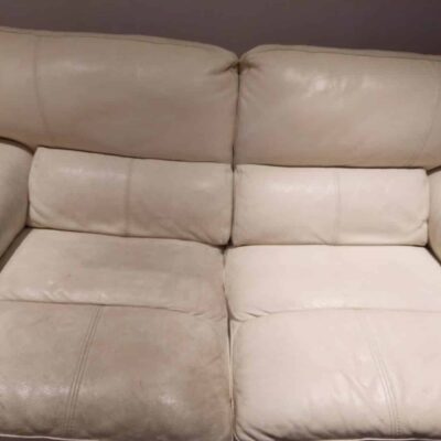 A white leather couch in a room.